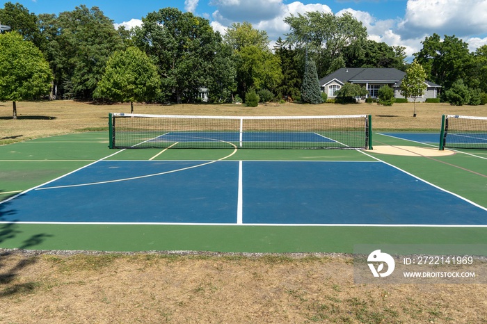 Empty Pickleball court blue and green recreational sport at an outdoor park.