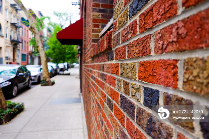 Beautiful buildings and red brick wall with texture close-up in Greenwich Village, Soho, Manhattan, New York, USA. Classic apartment building in New York City.