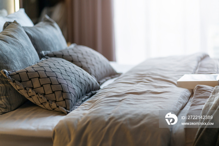 Bed maid-up with clean white pillows and bed sheets in beauty room. Close-up. Lens flair in sunlight.