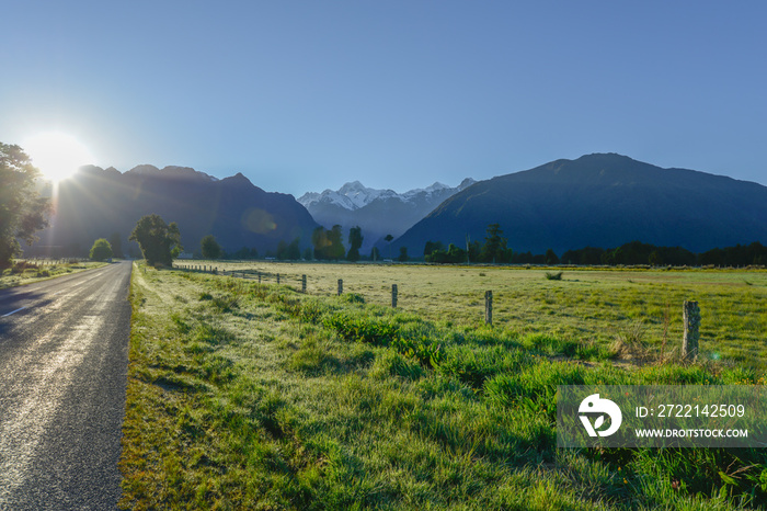 Country road among the meadows and mountains in New Zealand southland