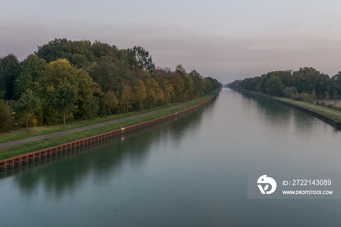 Straight water channel in germany munsterland at sunset in autumn