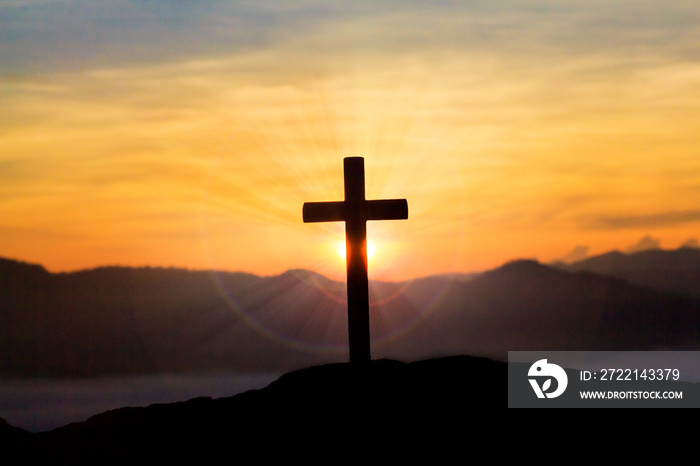 crucifix on mountain with colorful sky