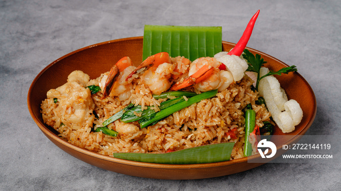 Chinese Kung Pao chicken and shrimp, close up in a bowl on grey background. Traditional Chinese Thai restaurant food