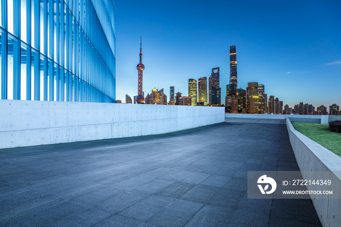 Empty square floor and city skyline with buildings in Shanghai at night, China.