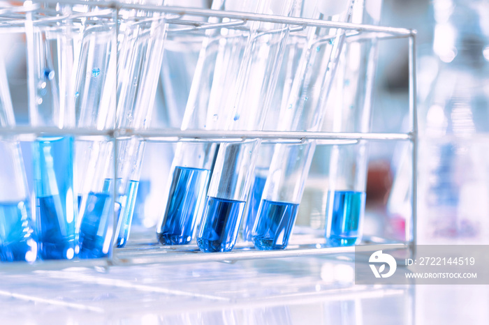 glass flask in chemical science education laboratory with molecular structure in blue background