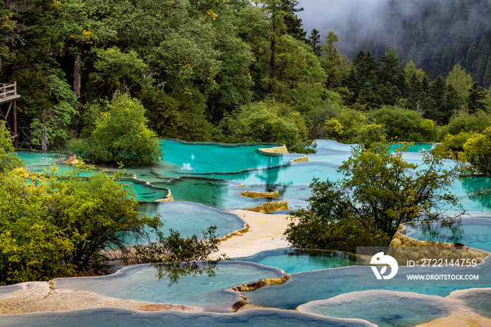 Huanglong National Park, Sichuan, China, famous for its colorful pools formed by calcite deposits. Situated at more than 3000m elevation, it is a UNESCO World heritage site