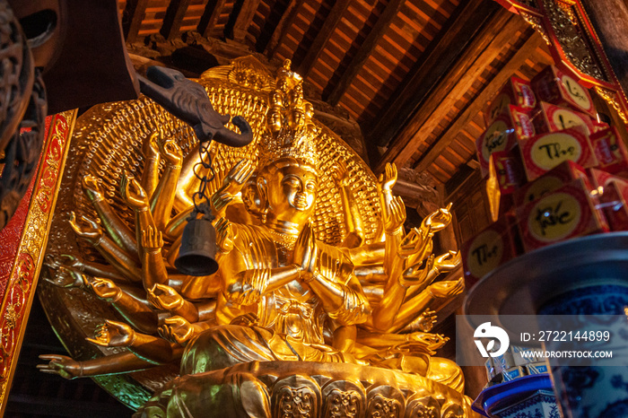 Golden statue of Avalokiteshvara goddess in a buddhist temple, Vietnam