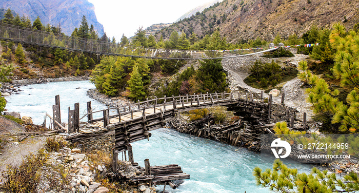 Wooden footbridge on the annapurna circuit, nepal