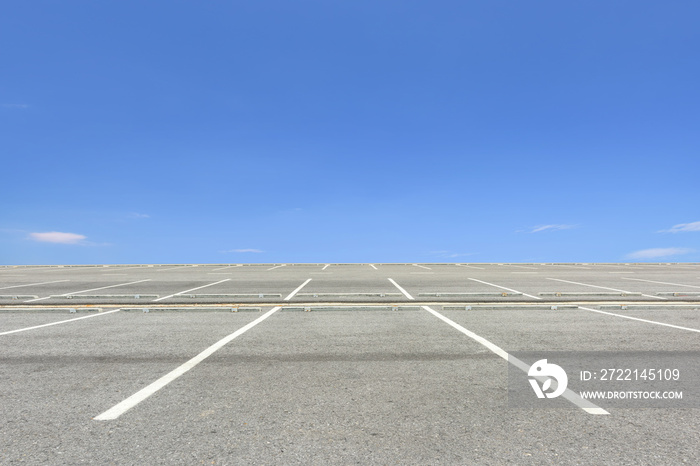 Empty parking lot against a beautiful blue sky