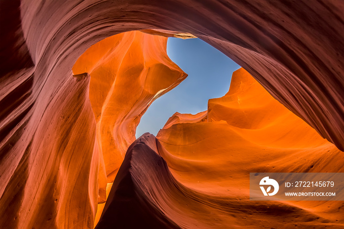 An archway in the rock gives a glimpse of the sky in Lower Antelope Canyon, Page, Arizona