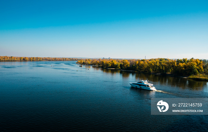 Beautiful new yacht and picturesque autumn river landscape