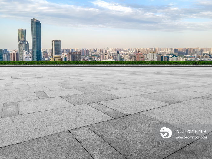 Empty brick floor with city skyline background