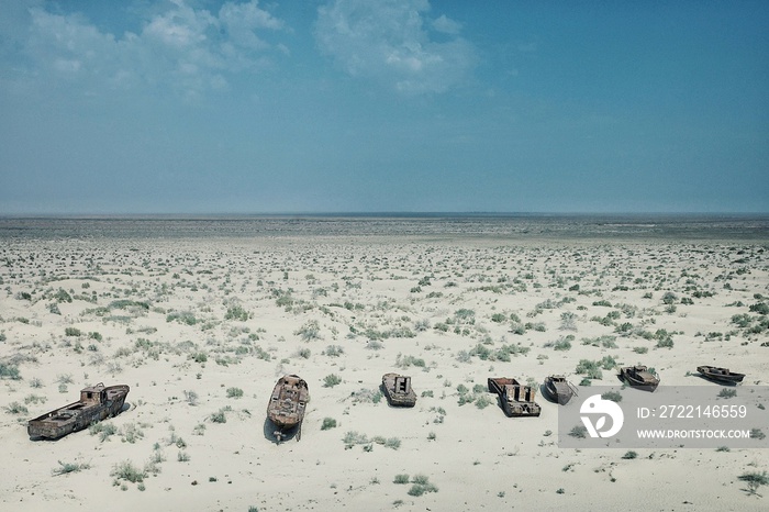 Moynaq / Uzbekistan - MAY 5 2010: abandoned boats rusting away in the sand at the once blooming sea port