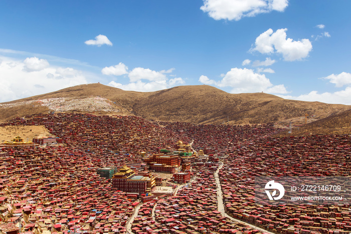 Red monastery and home at Larung gar (Buddhist Academy) in sunshine day and background is blue sky, Sichuan, China.