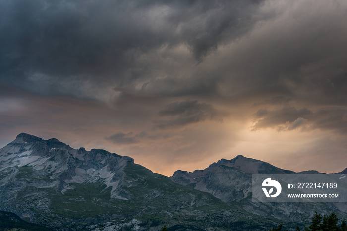 dramatic sunset in the French alps ,devoluy,with treatening storm clouds , concept of the danger of extreme weather in the mountains