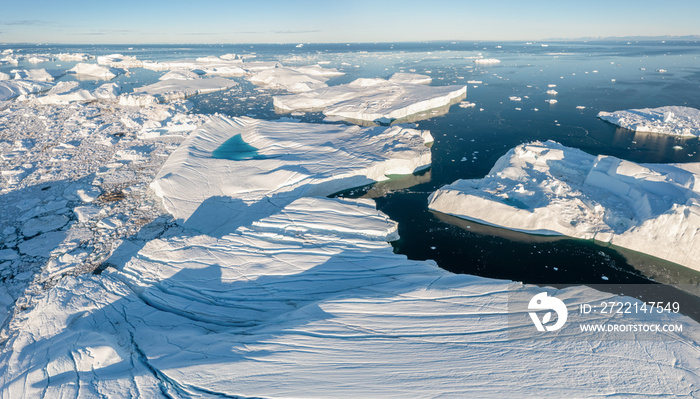 Climate change and global warming. Icebergs from a melting glacier in Ilulissat Glacier, Greenland. The icy landscape of the Arctic nature in the UNESCO world heritage site. Aerial view durin summer d