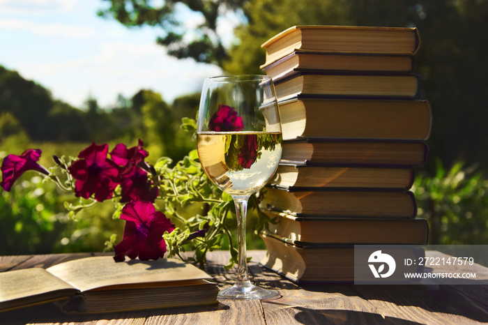 Sweet time with books, wine and flowers in the background.