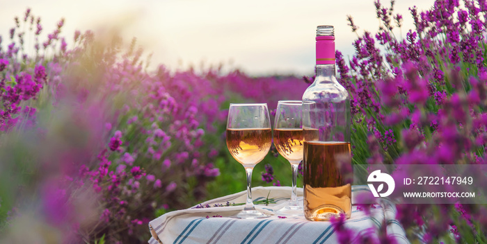 Wine in a lavender field. Selective focus.