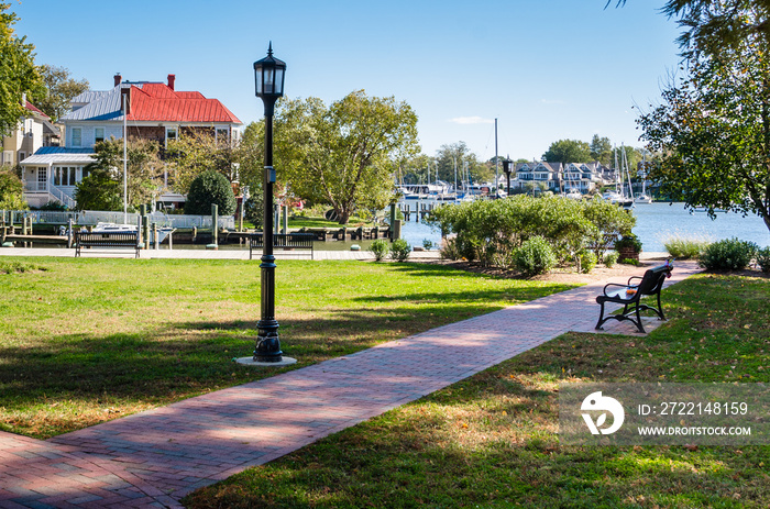 Small Harbourside Park with a Old Fashioned Lamp Post and a Metal Bench along a Paved Path. Annapolis, MD.