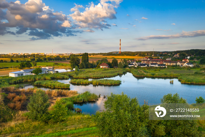 Beautiful scenery of the pond with amazing clouds before sunset, Poland