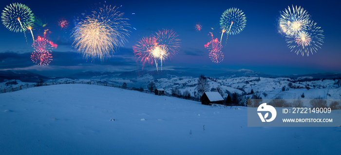 New Years firework display in winter alpine mountain landscape.