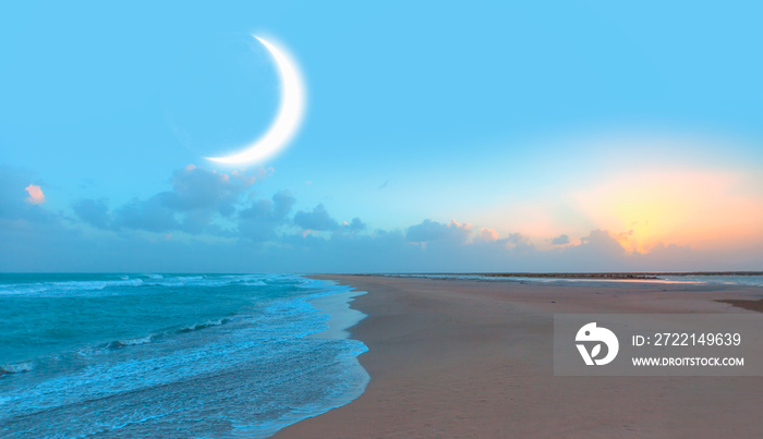 Crescent moon rising above calm sea in sunset sky  Elements of this image furnished by NASA