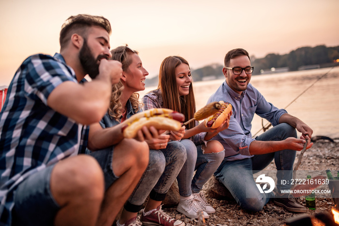 Group of friends grill and make hot dogs