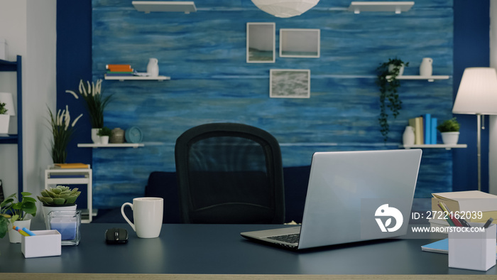 Empty workspace of freelancer worker with laptop computer on desk and cup of coffee. Interior of emp