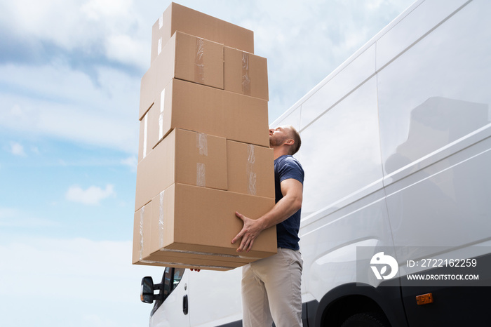 Movers Carrying Heavy Large Box Stack