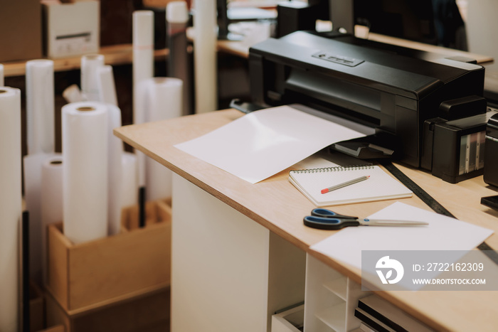 Office equipment, scissors, notebook with pencil, sheet of paper and ruler on wooden desk