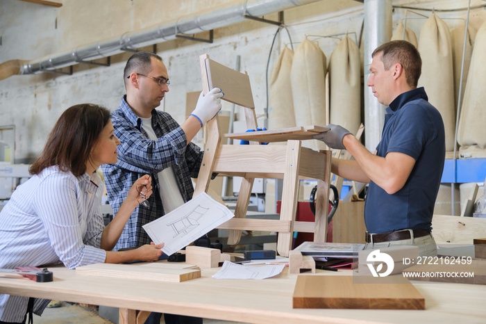 Group of working designers in carpentry workshop