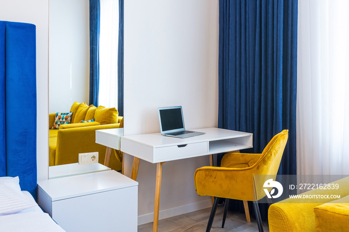 Interior photography, large bedroom in a modern loft style, with a double bed and a yellow sofa