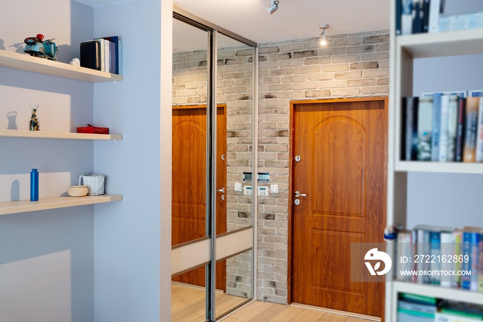 Entrance hall in modern apartment with mirror wardrobe