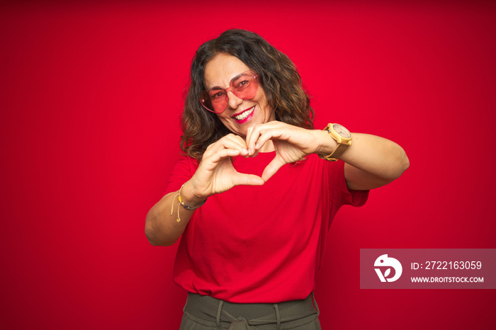 Middle age senior woman wearing cute heart shaped glasses over red isolated background smiling in lo