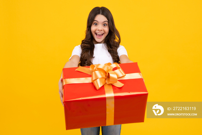 Amazed teenager. Portrait of teenager child girl 12, 13, 14, years old holding Christmas gift box. T