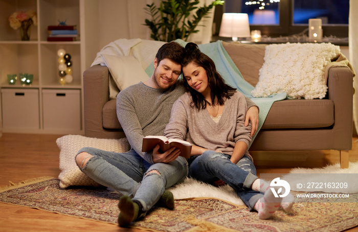 happy couple reading book at home