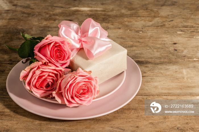 Romantic dinner table on rustic background. Love cutlery for Valentines or Mothers day, Wedding