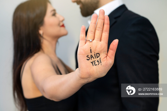 Romantic portrait of young couple in love hug. I just got engaged. Shallow depth of field and hand l