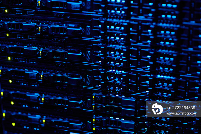 Background image of blade servers stacked in data center with blinking neon lights, copy space