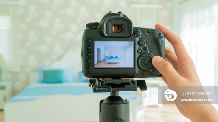 Camera on a tripod in bedroom interior, Professional DSLR digital camera, selective focus, Horizonta