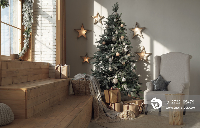 Sunny decorated room for Christmas with tree and armchair