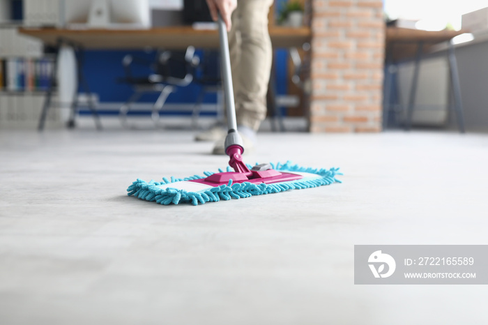 Person wiping floor with fluffy mop, domestic work, housewife cleaning at home