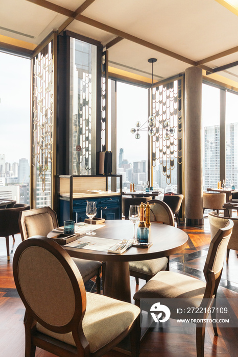 Modern luxury decorated interior restaurant that can view Bangkok cityscape. Elegant design for fine