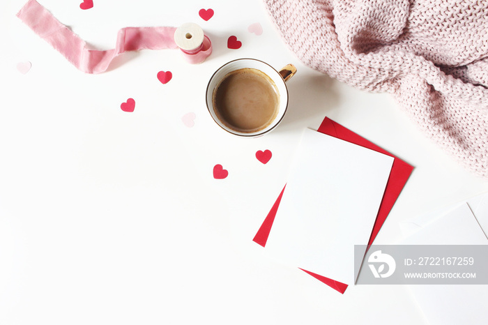 Valentines day or wedding still life scene. Cup of coffee, envelope, paper hearts confetti, knitted 