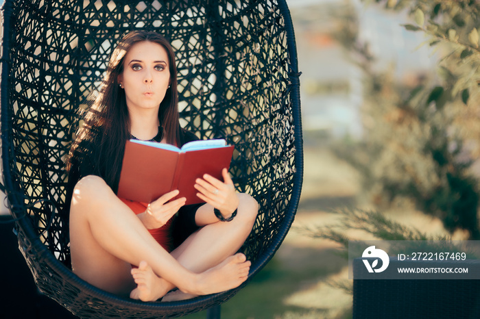 Summer Girl Reading a Novel Outdoors in Nest Chair