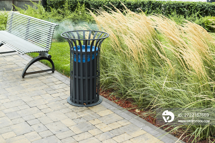 Park benches and trash cans in the open air