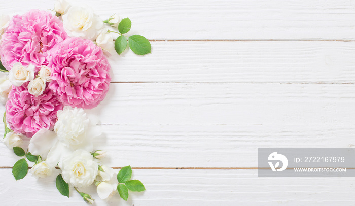 pink and white roses on white wooden background