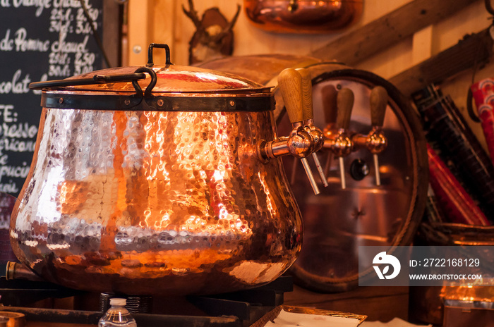 closeup of mulled wine in traditional copper cauldron at the christmas market