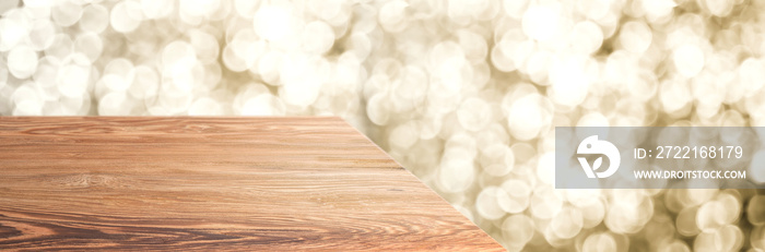 Empty old rustic wood table top with blur sparkling gold bokeh abstract background,panoramic banner 