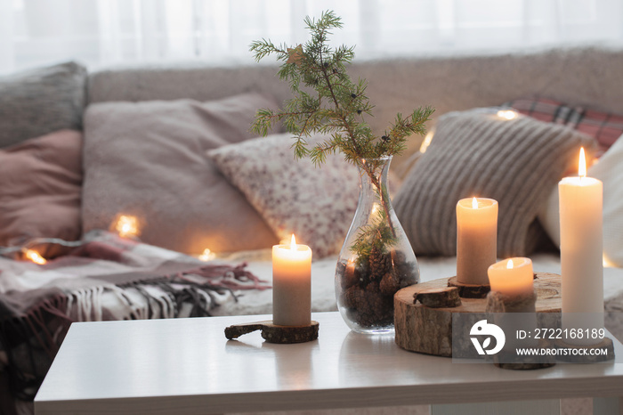 Composition of candles on  white table against the background of